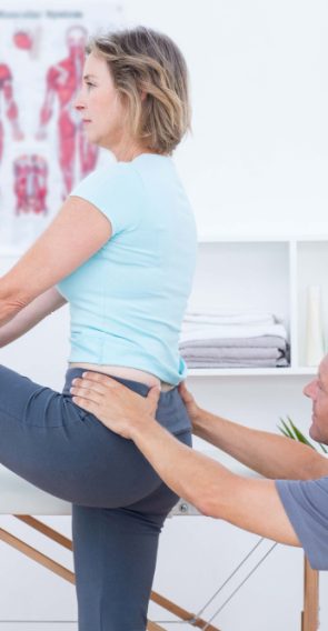 physiotherapist-examining-his-patient-back